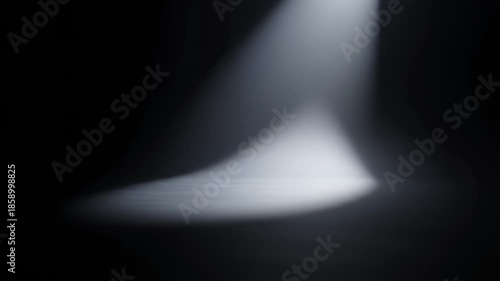 Spotlight Shining Down on Empty Stage in Dark Room