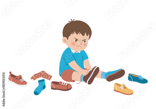 A young boy sitting and tying his shoes with various shoes and socks