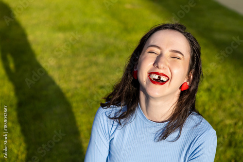Mature Caucasian brunette woman missing a front tooth. Adult toothless woman