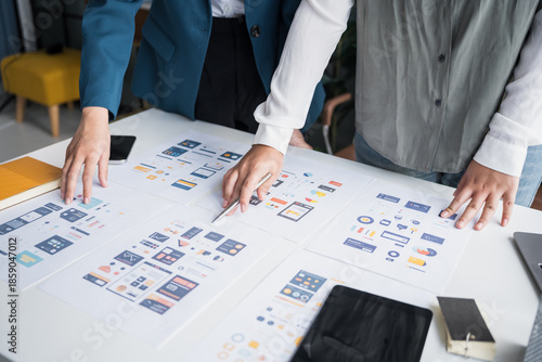 Fototapeta Developer team brainstorming user interface and experience designs for mobile application&nbsp;ux ui graphic prototype.