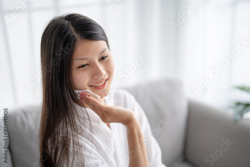 Free Download Daily beauty routine Asian woman
with clean skin uses micellar water to remove makeup - GFXLoad