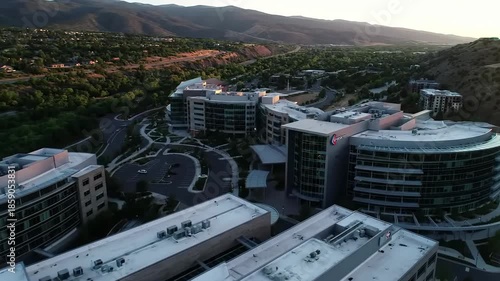 Wallpaper Mural Aerial view of a large medical complex with modern buildings and parking lots surrounded by trees and mountains Torontodigital.ca
