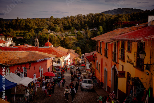 Colorful street with people in traditional Mexican town
