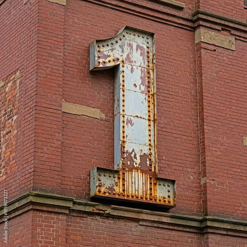 large metal number one on brick building exterior