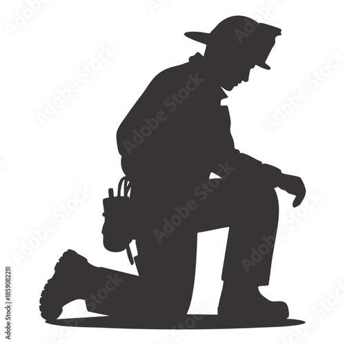 Firefighter kneeling with head bowed in a moment of reflection or sorrow, stark black silhouette.