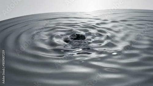 A visually stunning slow motion fluid displacement effect where smooth, gray liquid topology ripples endlessly across a clean blank white surface topology ripples, science, modern