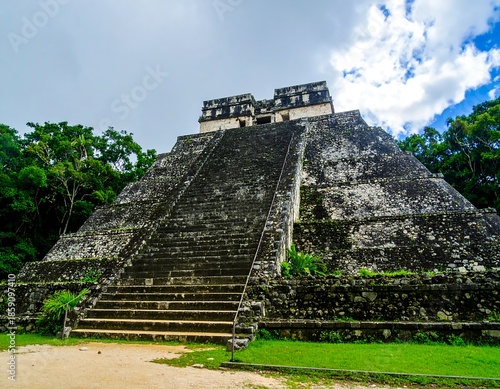 Ancient pyramid structure in lush green jungle