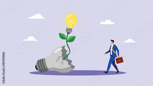 Businessman walking past a plant with a glowing light bulb growing from a broken bulb.