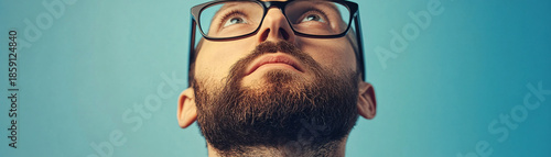 young man looking through a window