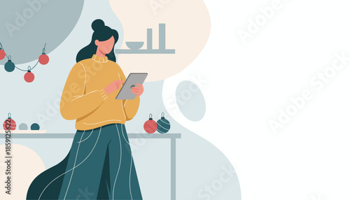 Modern woman uses digital tablet in a festive interior decorated with Christmas ornaments
