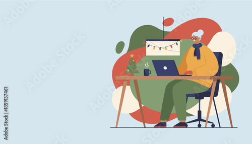 Senior woman uses laptop for remote work in a cozy holidaydecorated home office Digital communication