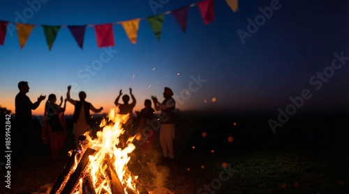 Friends gathered around bonfire at sunset with colorful flags