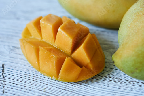 Ripe mango fruit on a wooden background. Close-up.