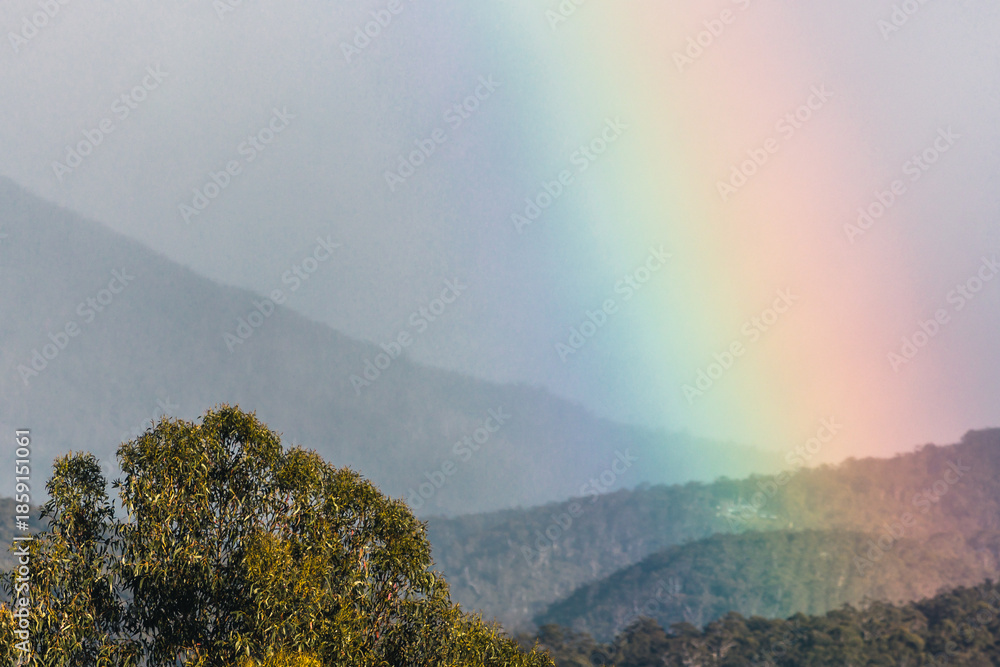Fototapeta premium serene morning rainbow over tasmania mountains and hills, unedited apart from color grading