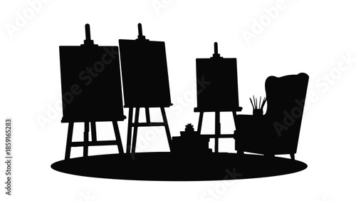 Artist's studio with easels, canvases, and a comfortable chair for inspiration.