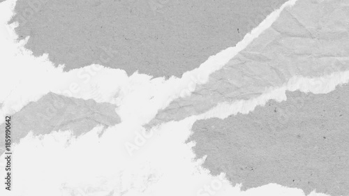 Textured paper background revealing torn edges in grayscale abstract for artistic designs