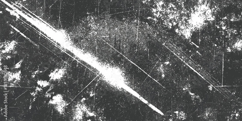 Aged and distressed black and white grunge background texture with bright diagonal light leak