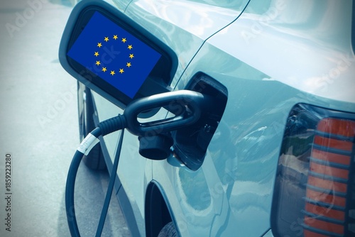 Charging plug in an electric car with flag of the European Union EU.