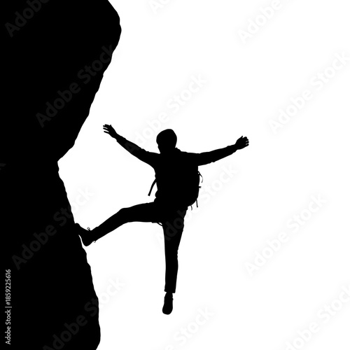 Silhouette of a rock climber reaching for the top of a cliff
