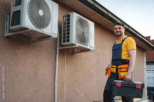 фотографія Air conditioner technician installing new air conditioners on a wall