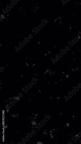 Abstract Black Background with Subtle White Speckles and Grainy Texture Overlay.