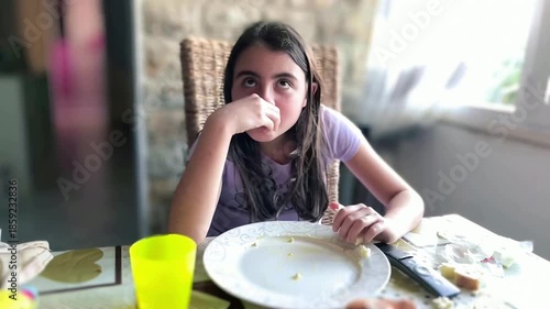 Young girl eating at the table