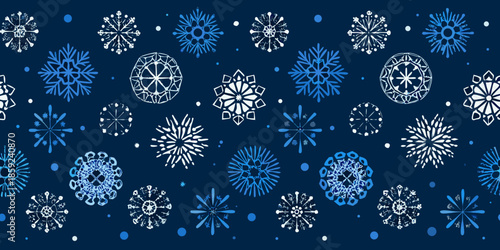 Intricate patterns of white and blue snowflakes on a dark navy background