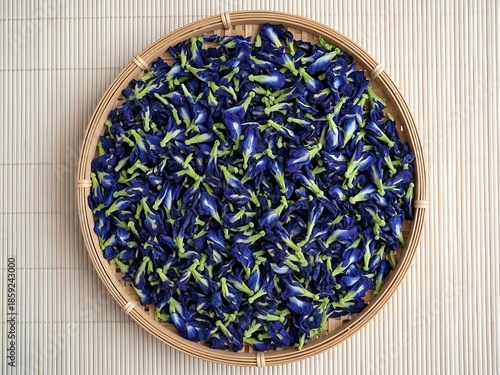Dried butterfly pea flowers in a round bamboo basket