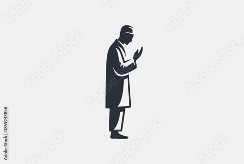 A silhouette of a Muslim man standing and praying with hands raised in a gesture of devotion and worship.