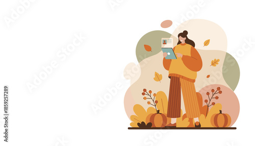 Happy woman reviewing digital documents on a tablet surrounded by fall leaves and pumpkins Autumn work concept