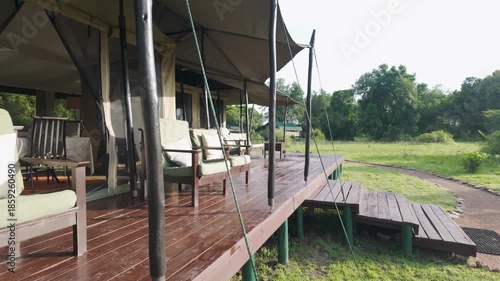Comfortable outdoor seating on porch of mess tent at Porini Lion Camp, Kenya