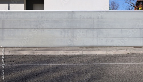 Wallpaper Mural Gray plaster striped fence with white house on behind. Concrete sidewalk and street in front. Background for copy space Torontodigital.ca