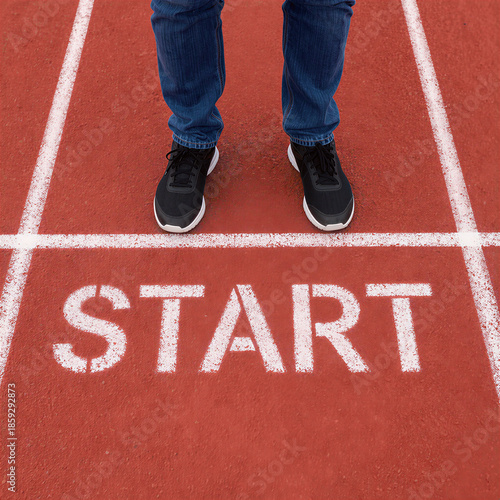 Sneakers at Starting Line on Red Track with START Text