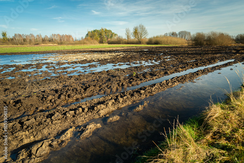 View of a plowed field with puddles of water after the melt