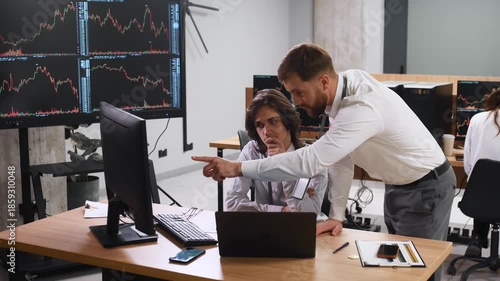 Thinking, talking the strategy. Two male exchange workers are in the office together.