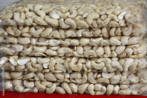 Stacked clear plastic bags filled with cashew nuts.
