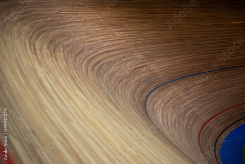 Very sharp turn with special wood surface. Taking turn on cycling track. Dangerous banked turn for maximum speed. Cycling competition. Closed circuit for bicycles with sharp turn