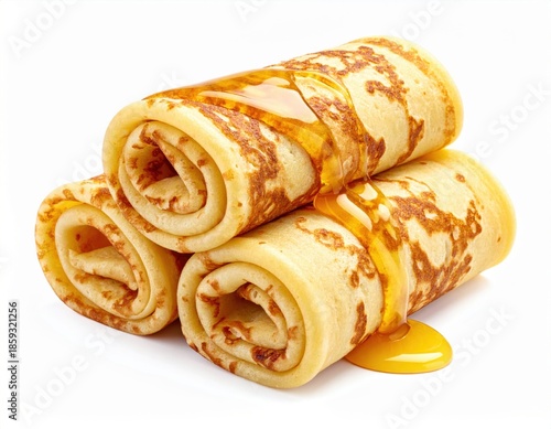 Three golden rolled pancakes are elegantly presented on a white background, generously drizzled with sweet honey forming a tempting pool
