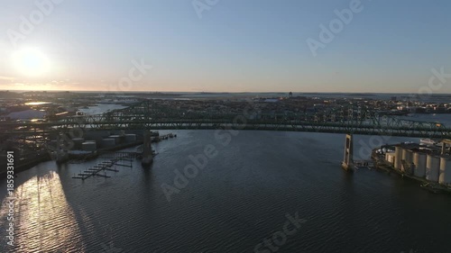 Wallpaper Mural Aerial view of the bridge along U.S. Route 1 over dark water, with industrial buildings and a marina visible on the banks, Boston, Massachusetts, United States. Torontodigital.ca