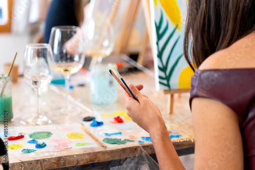 Photos Woman enjoying sip and paint event creating art