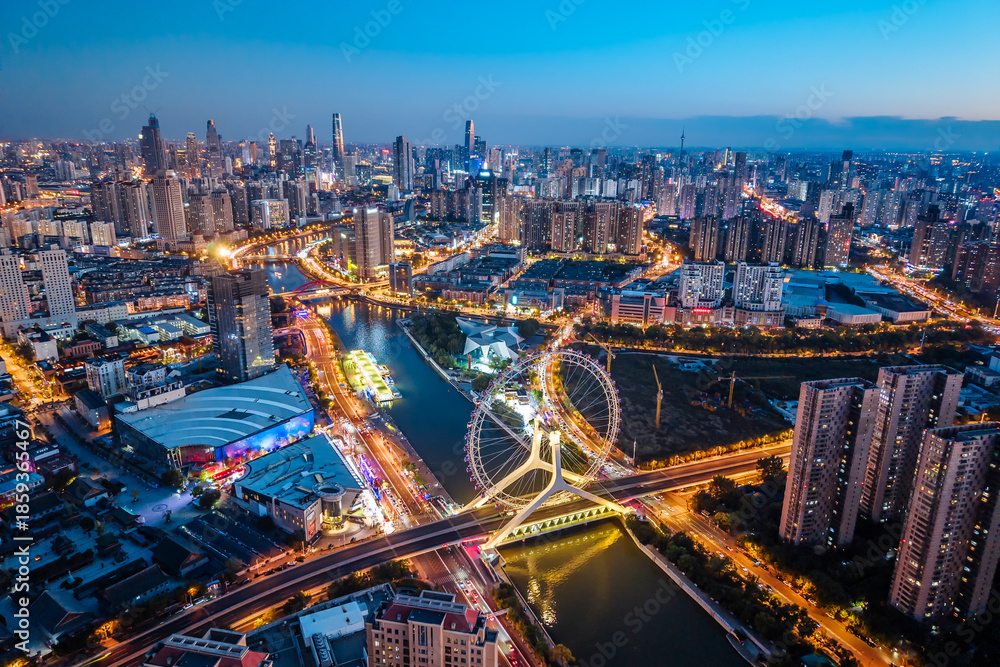 Fototapeta premium Aerial night view of the Tianjin Eye Ferris wheel over the Haihe River in Tianjin, China