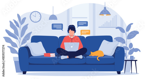 Young man sitting comfortably on sofa with laptop and headphones while working from home in a cozy living room with cat.
