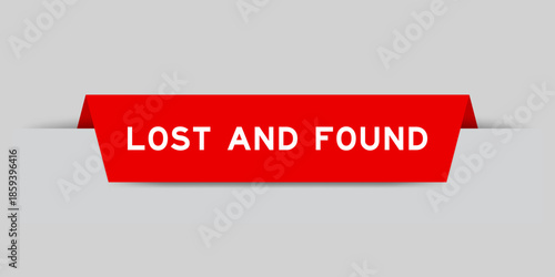 Red color inserted label with word lost and found on gray background