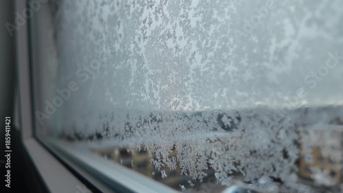 Winter window view, snowflakes and ice on glass