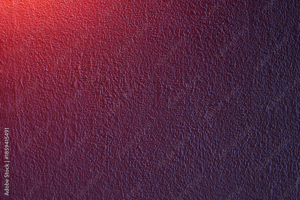 Fototapeta premium Rough painted wall with red to blue gradient, visible grain and dramatic color shift. Expressive abstract surface with strong contrast and tactile texture. Copy space