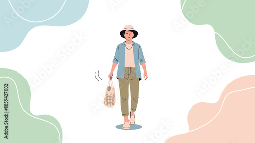 Stylish woman in casual summer outfit carrying a checked bag and wearing a wide-brimmed hat
