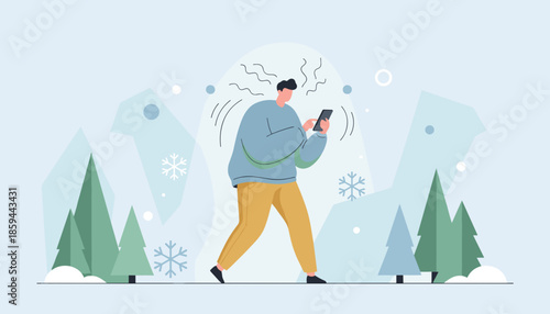 Man walking in a snowy landscape intensely focused on his smartphone struggling with poor signal