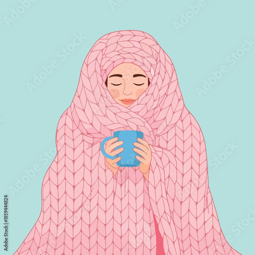 Woman wrapped in pink blanket holding mug.