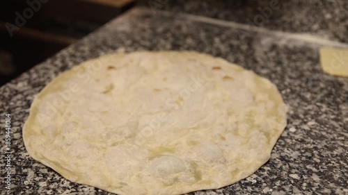 A chef makes makes lavash for shawarma.