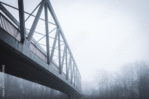 Metal bridge on the Mittellandkanal in Bramsche, Germany, in winter fog — moody canal landscape